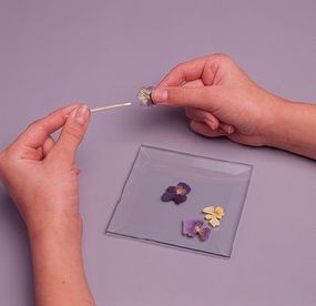 Glue the flowers onto the beveled glass.