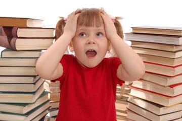 toddler surrounded by books