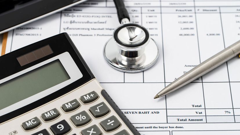medical bills, stethoscope, calculator