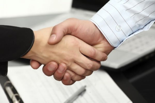 Businessman handshake in greeting seals agreement.
