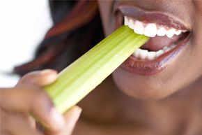 Woman eating celery