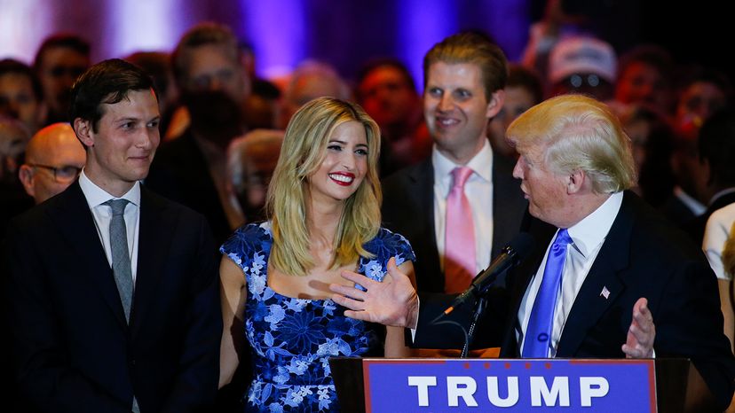 Jared Kushner looks on as his wife Ivanka Trump smiles at Donald Trump during a speech.