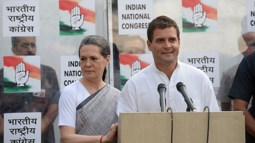 Indian National Congress President Sonia Gandhi looks on as Vice President Rahul Gandhi speaks during a press conference.