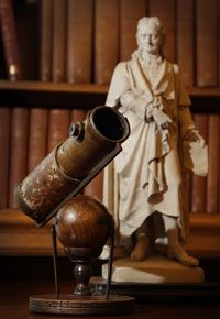 Newton's telescope rests next to a statue of the great man at the Royal Society in London.