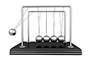 In a Newton's cradle, when the ball on the end strikes the others it sends the one on the opposite end into the air. But why are the balls in the middle so calm?