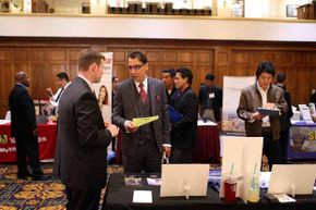 A job seeker chats with a recruiter at a job fair in San Francisco. What can you do to make networking less painful? 
