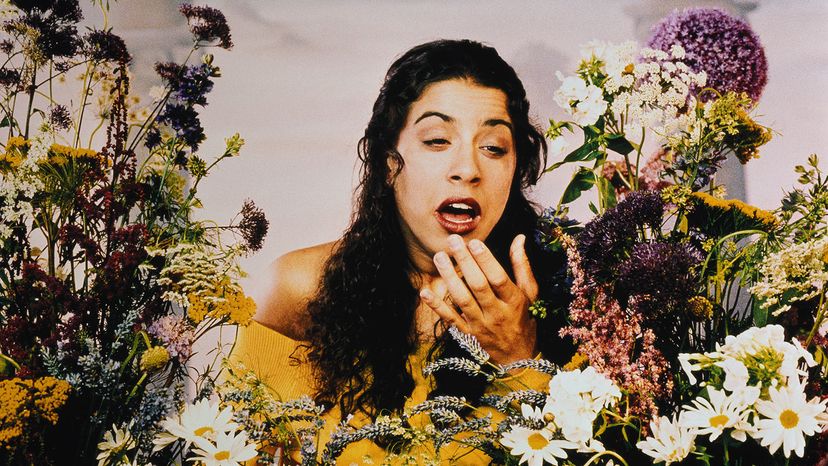 Woman sneezing with flowers