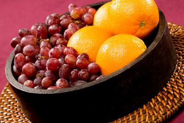Bowl of grapes and oranges
