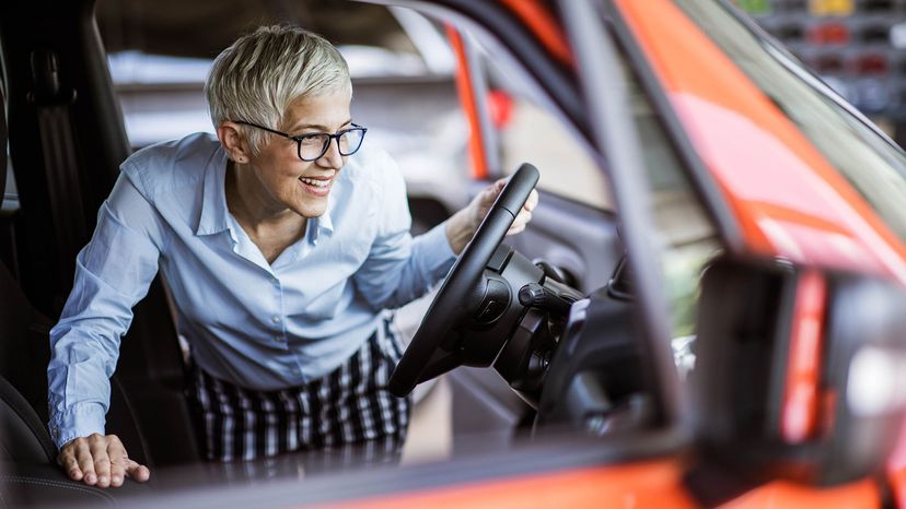 mature woman looking at new car