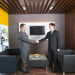 People shaking hands to start a meeting. 