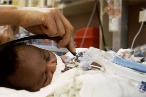 A doctor cares for a baby in the NICU.