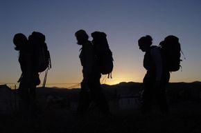 people hiking on the Camino de Santiago at sunset