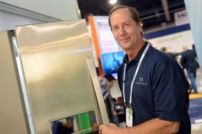 Employee Robert Kodweis from company Arrayent talks about the Internet of Things next to a refrigerator at the 2014 Consumer Electronics Show (CES) in Las Vegas. Arrayent makes an IoT platform.