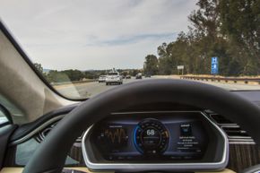 View through the windshield of the 2013 Tesla Model S as the Google self-driving car motors along the San Francisco freeway.