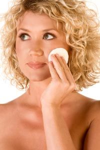 Woman using no rinse facial cloth.