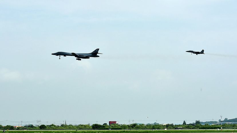 A U.S. Air Force B-1B Lancer bomber (L) flies with a South Korean F-15K fighter jet over the Korean Peninsula after North Korea's ICBM test on July 30, 2017. South Korean Defense Ministry via Getty Images