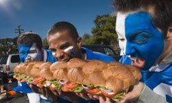 Tailgaters eating sub sandwich