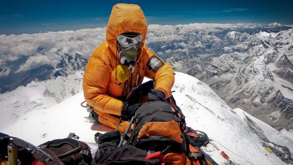 Climber on summit of Mount Everest