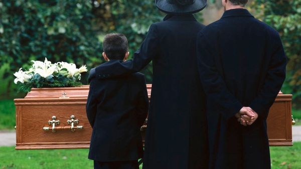 family standing in front of coffin