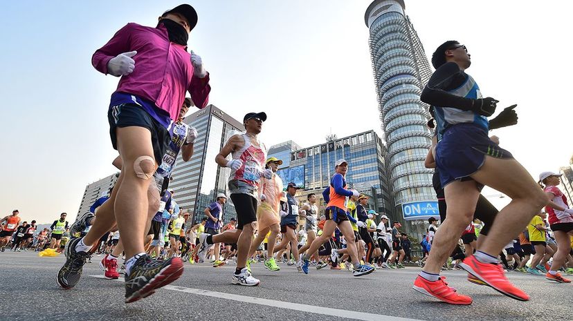 Athletic men competing outdoors in sport.