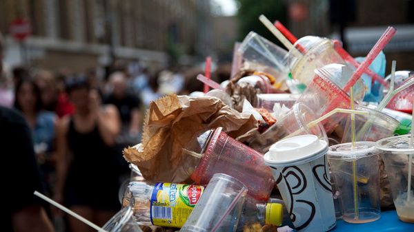 trash can full of plastic cups and cans