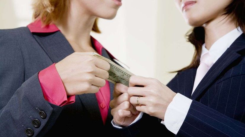 Two women fighting over a dollar bill.