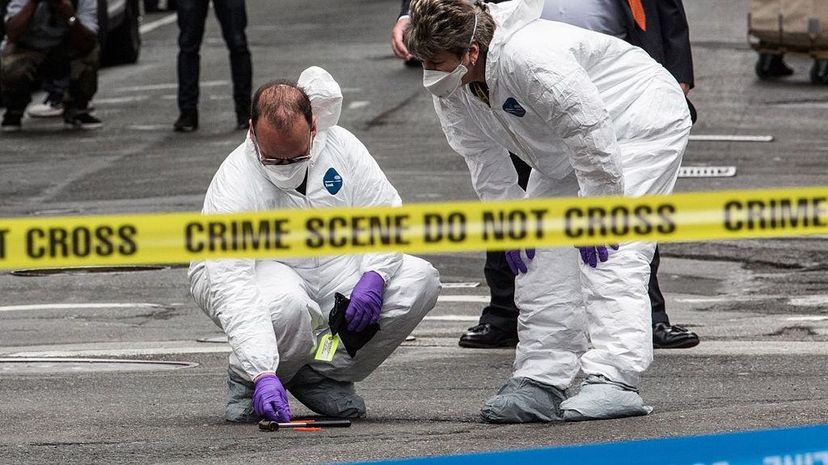 Crime scene investigators inspect a hammer used in an attack on a police officer on May 13, 2015 in New York City. Unlike what is portrayed on TV shows, DNA evidence is not always cut and dried. Andrew Burton/Getty Images