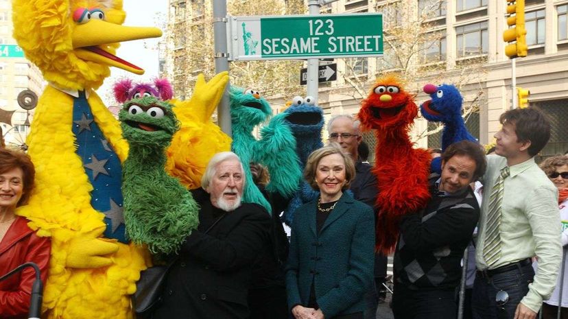 Puppeteer Caroll Spinney (who animates Big Bird and Oscar), Sesame Street co-founder and TV producer Joan Ganz Cooney, and Sesame Street cast members pose under a '123 Sesame Street' sign at the 'Sesame Street' 40th Anniversary temporary street renaming. Astrid Stawiarz/Getty Images