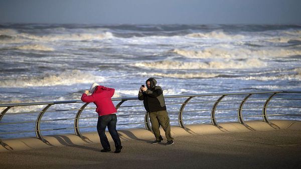 people standing in high winds