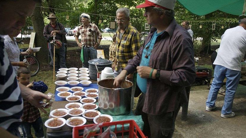 Collinwood Kid serves mulligan stew with park district employees at a 2007 hobo gathering at Deep Lock Quarry near Akron, Ohio. While the glory days of freight trains have long passed in America, there remains a loyal contingent of hobos and wannabes. CHUCK BOWEN/AFP/Getty Images
