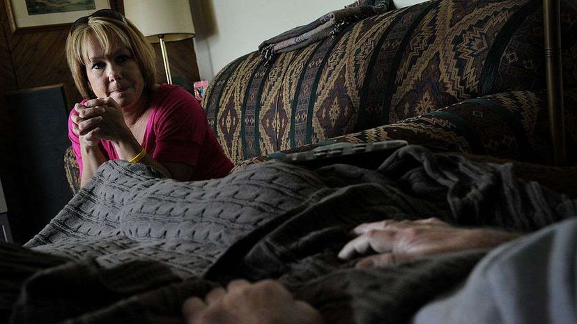 Deborah Jones cares for her husband Gary who suffers from Lou Gehrig's disease and is enrolled in Hospice in Grand Junction, Denver. Here he is visited by his hospice case manager, Becky Byrum, RN. Craig F. Walker/The Denver Post via Getty Images