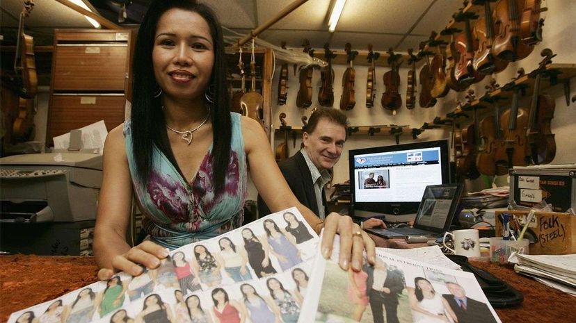 Lawrence Lynch poses with his Thai wife Thapenee, in Kidderminster, England, in 2006. The couple, who run a U.K. mail order bride agency from their music shop, have arranged hundreds of Thai women for clients and now use the Internet to introduce Weste... Christopher Furlong/Getty Images