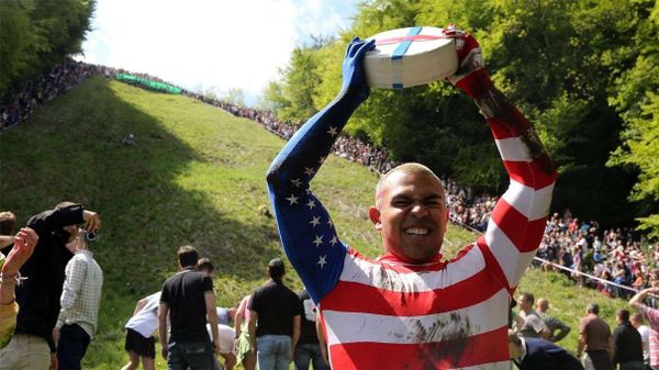 Kenny Rackers celebrates his cheese-rolling victory