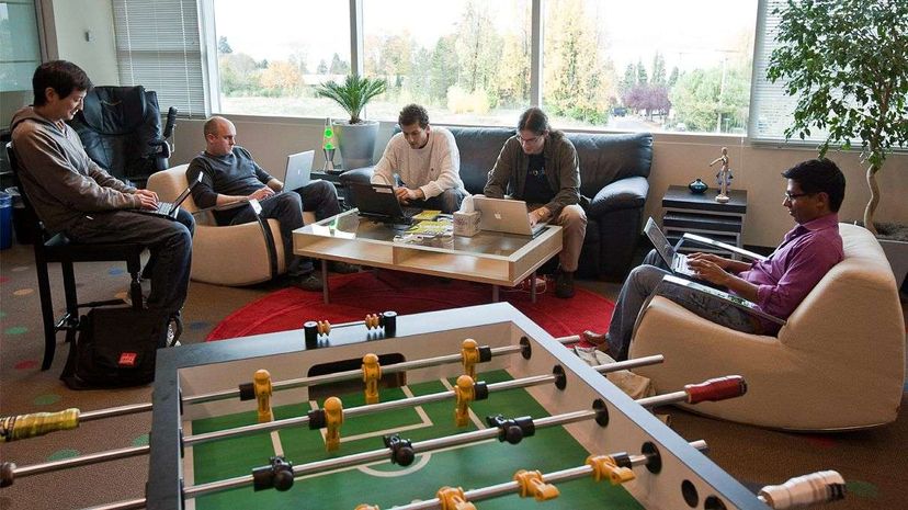Google software engineers work in a room with a view and an unused foosball table at their Kirkland, Washington office.  Other Google amenities include a gym, soda fountain and rock climbing wall. Stephen Brashear/Getty Images