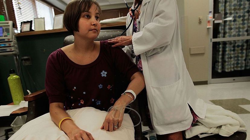 Cancer patient Caroline Whitley has her vital signs checked by a nurse as she gets her chemotherapy treatment at the Cape Fear Valley Cancer Center in Fayetteville, North Carolina. Forty percent of 40 percent of cancer clinical trials were unable to en... Chris Hondros/Getty Images