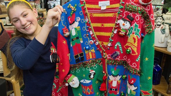 woman holding Christmas sweater