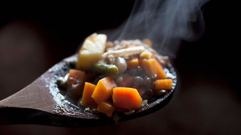 Which sounds more satisfying when you're hungry, warm stew or a plate of raw vegetables? Tobias Titz/Getty Images