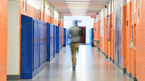 student walking down school hallway
