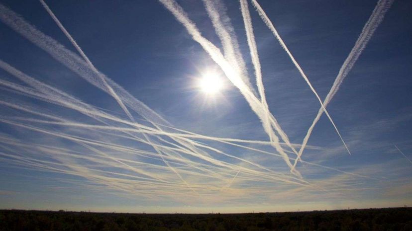 The atmospheric phenomenon left behind airplanes are called contrails, and have become fodder for conspiracy theorists. Bert Modderman/Getty Images