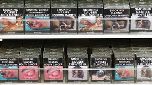 Australian cigarette packages featuring image warnings on shelf