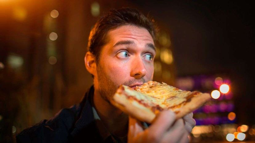 If that guy were following time-restricted eating, he wouldn't be indulging in that late-night slice. Steven Prezant/Image Source/Getty