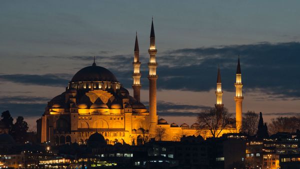 Famous minaret glows in night's sky.