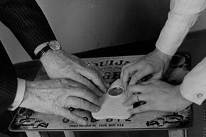Two people play the Ouija board in 1972. The basic design has not changed in more than 100 years.