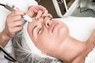 Woman receiving facial treatment.