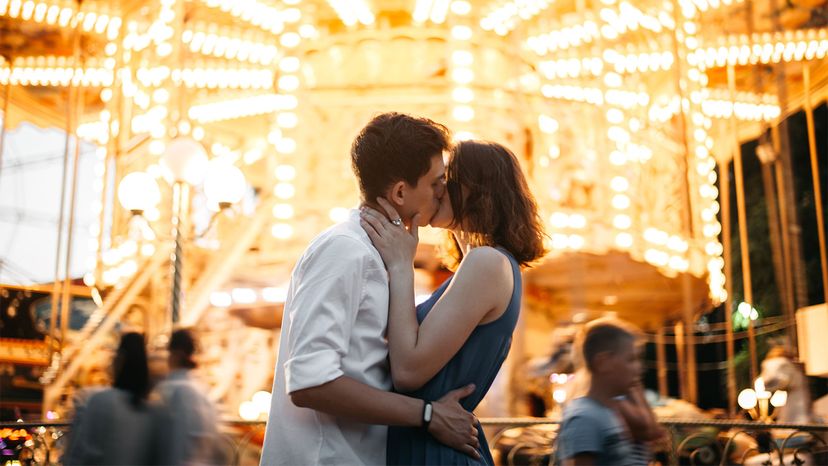 couple kissing on carousel 