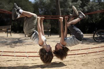 twins on ropes in park