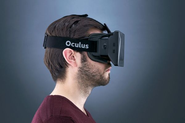 A man wearing a test model of the Oculus Rift VR headset