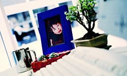 Blue picture frame holding a photo of a small child.