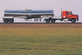 Semi truck transports industry via transportation mode.