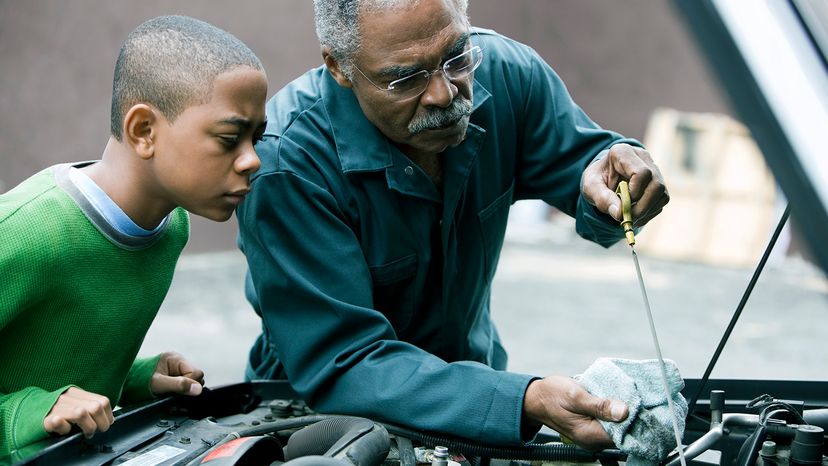 man checking oil